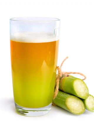 Sugar cane fresh juice isolated on white background.